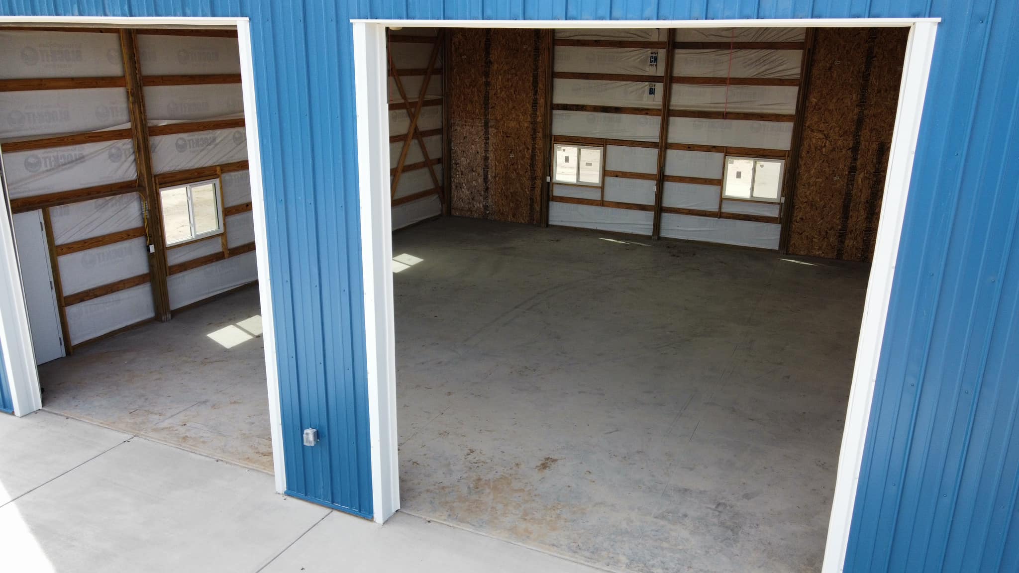 Fat Puppy Construction featured project: blue and white post frame suburban workshop