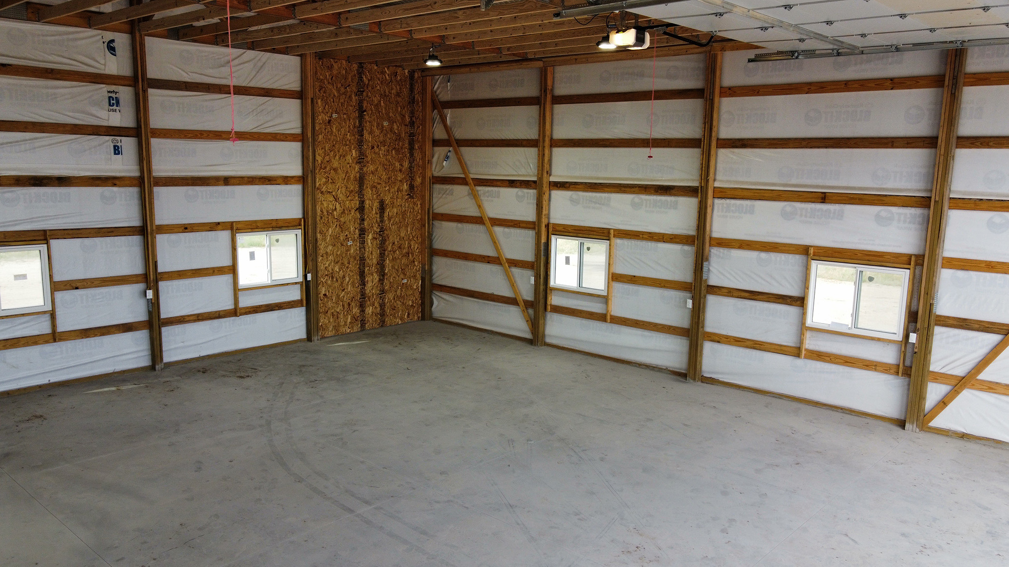 Interior of Fat Puppy Construction featured project: blue and white post frame suburban workshop